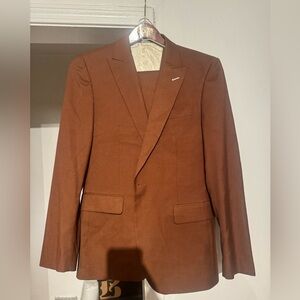 This is a 3 piece men suit in the color brown.